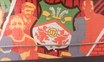 Mural on brick wall of the Racecourse Ground, home of Wrexham AFC